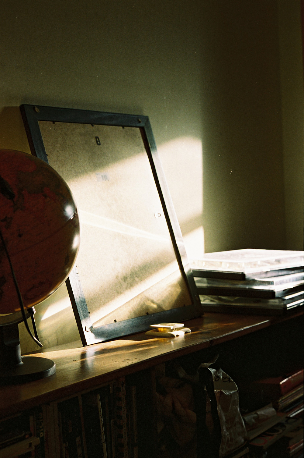 Analog photo of multiple objects on a table reflecting light coming from the right.