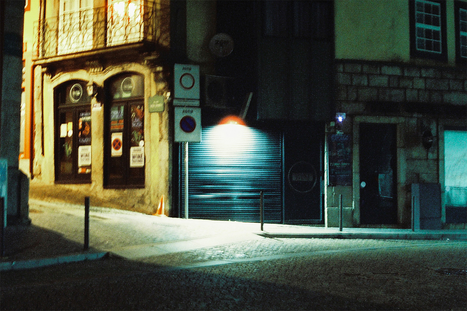 Analog photo of a closed store at night.